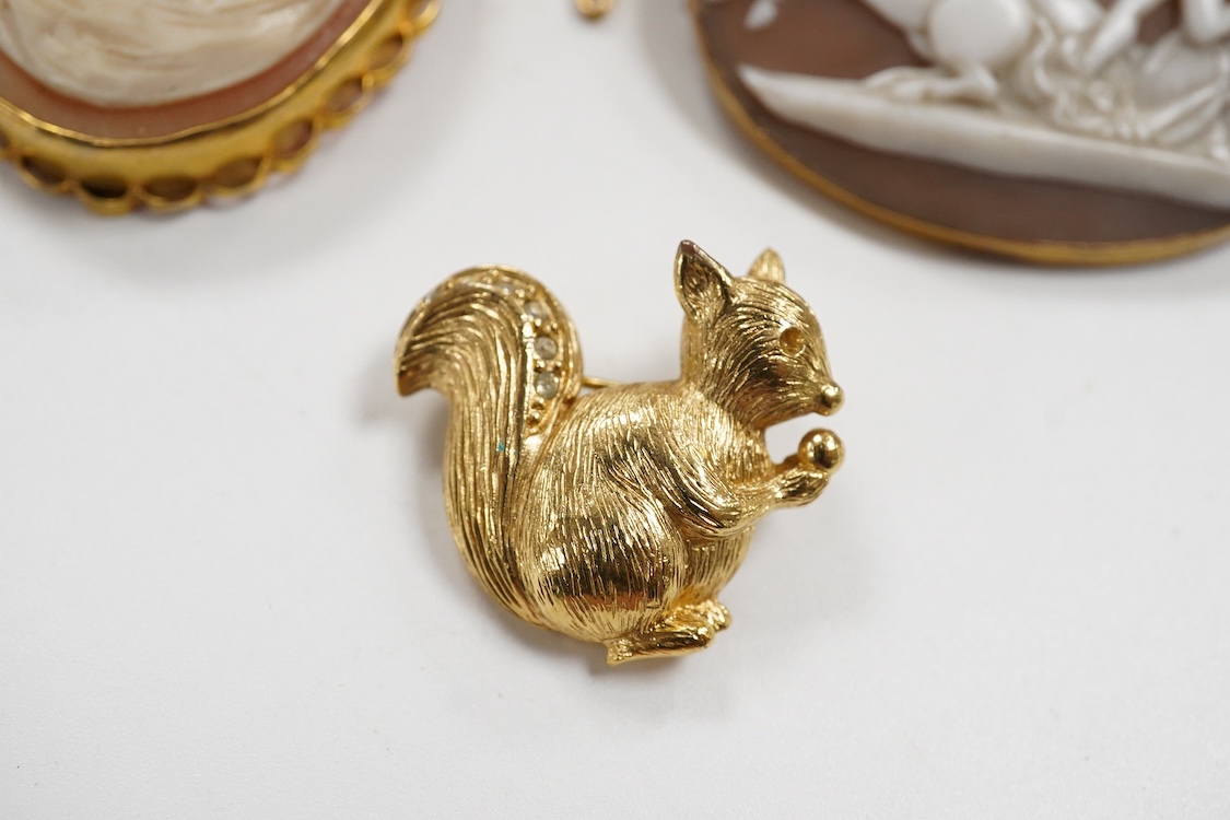 A collection of jewels, comprising: an Art Deco green and colourless paste jabot pin; two shell cameo brooches, depicting a lady in profile, length 4.7cm, stamped 9ct, and Sol's chariot respectively; and a gilt metal and